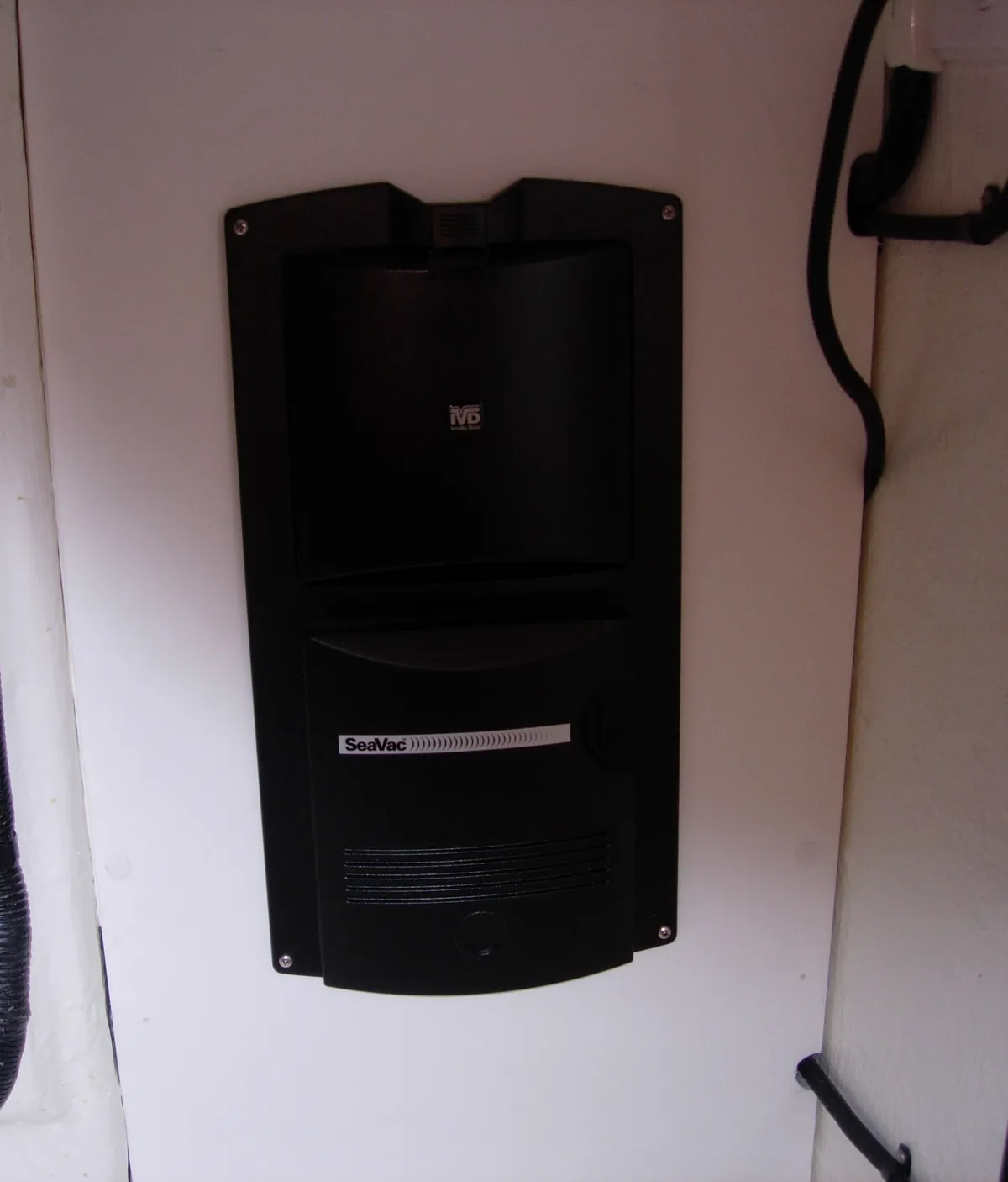 An earlier SeaVac, wall-mounted. The RM-family unit the SeaVac Ultra is built on, fitted in a dry equipment space below deck. The SeaVac name is on the front.